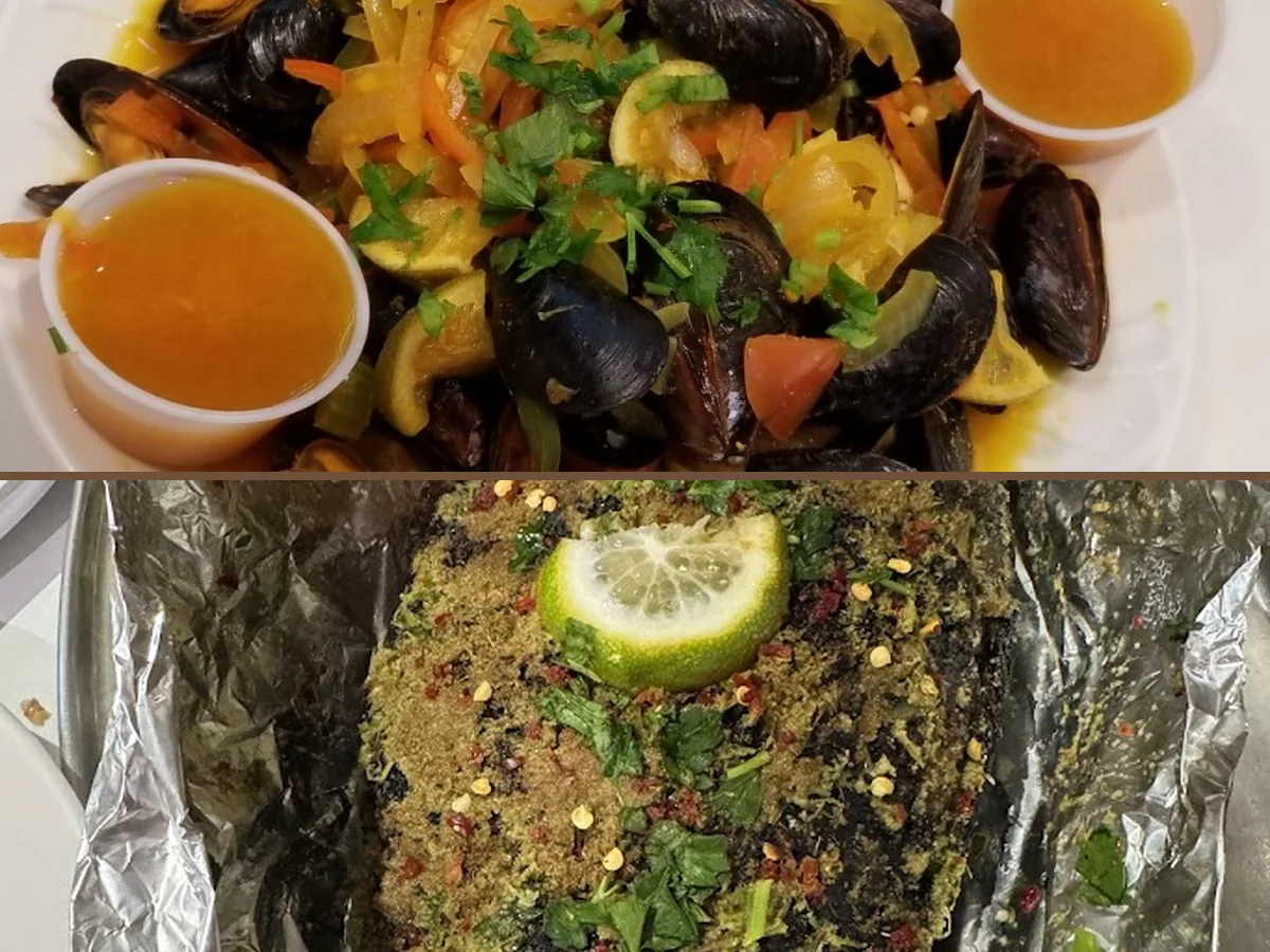 Plates of Mediterranean seafood on a simple table.