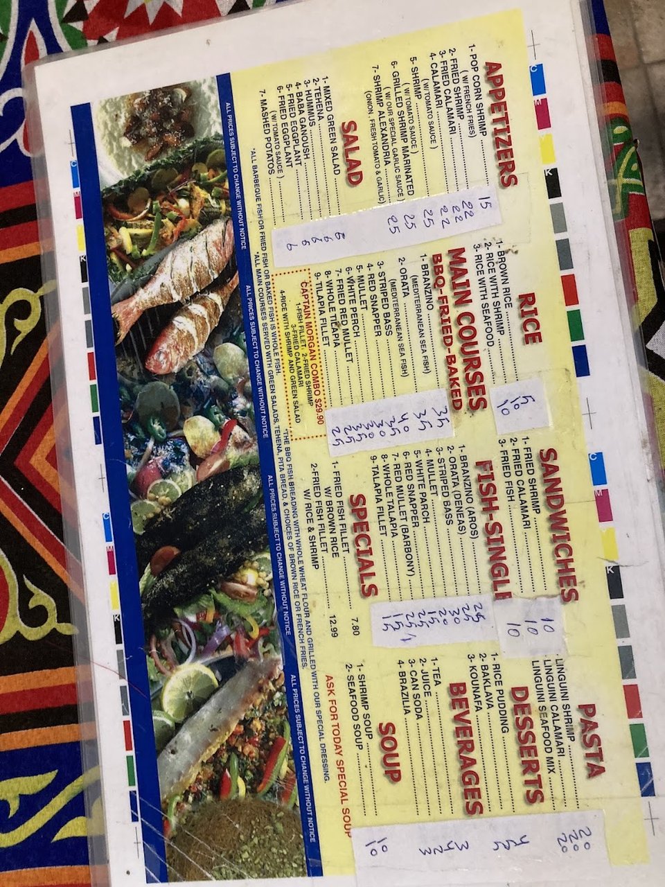 Restaurant menu with branzino and shrimp dishes.